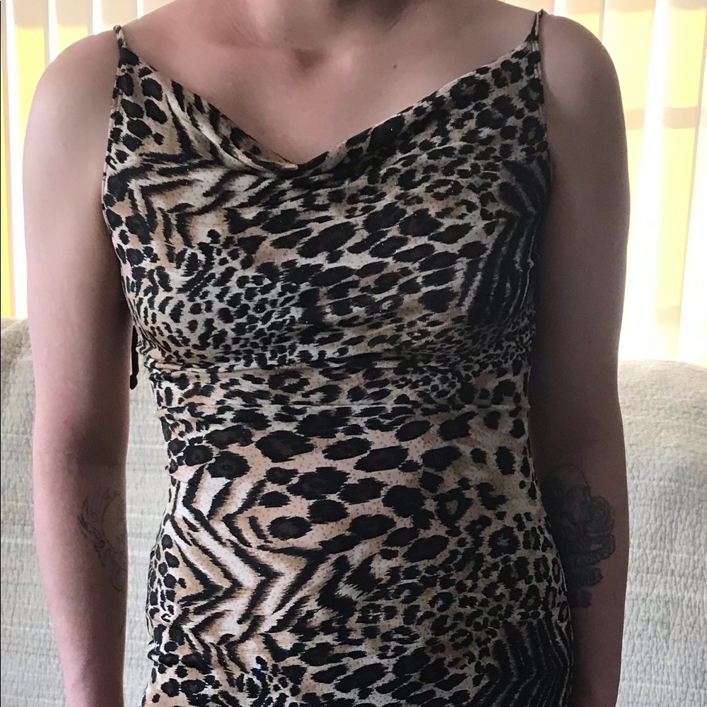 Tiger, Leopard, and Cheetah prints adorn this sparkly spandex, cowl neck.